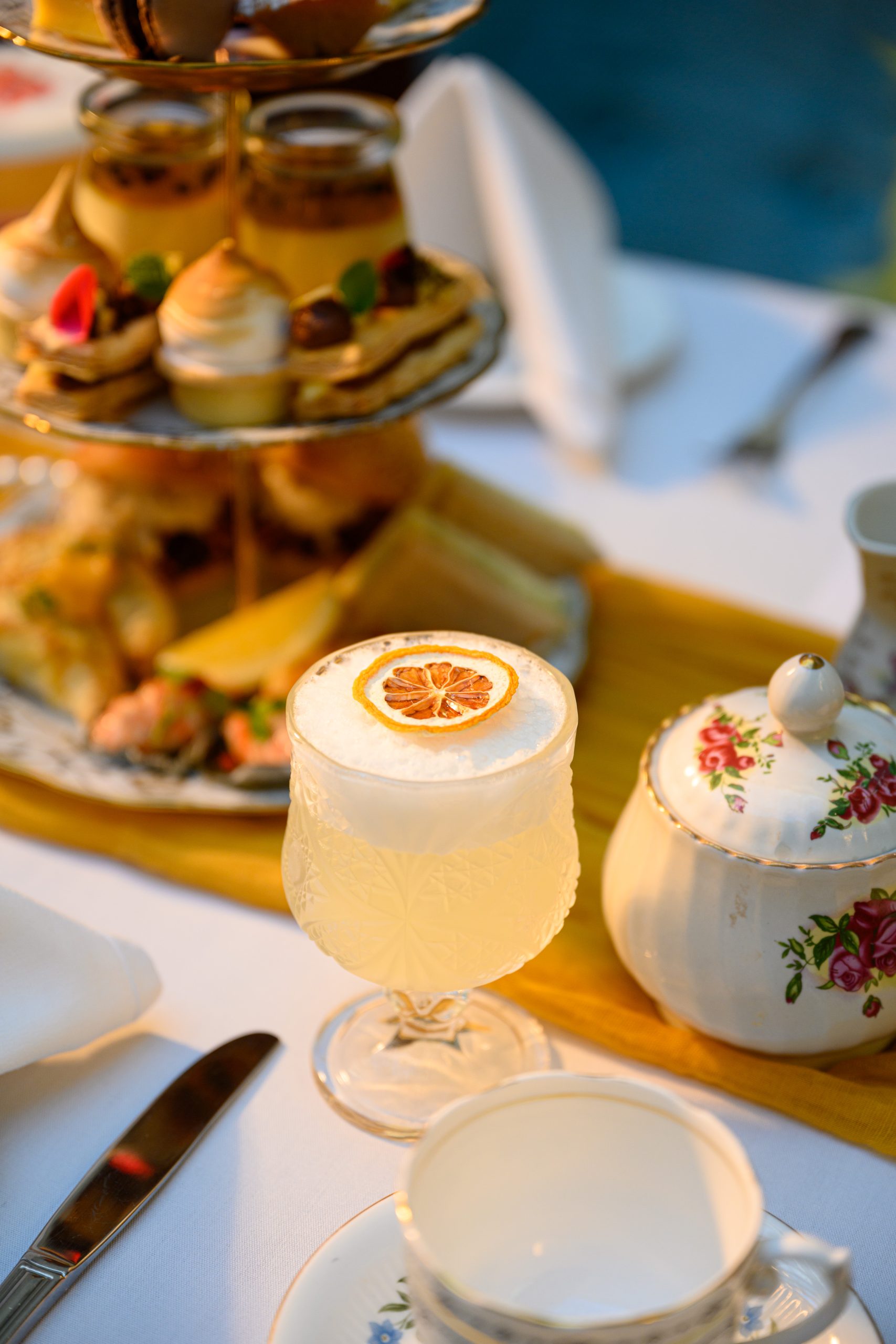 Close up of a cocktail and the food platter at Hotel DeBretts High Tea